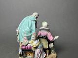 an image of a figurine of a man and woman sitting on a chair