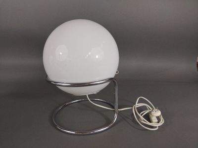 a lamp that is sitting on a stand on a table