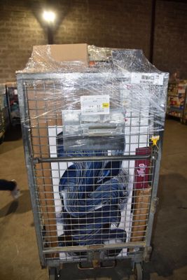 a metal cart with luggage inside of it in a warehouse