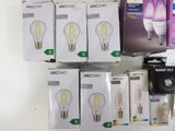 boxes of light bulbs are stacked on top of each other on a shelf