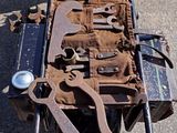 an old motorcycle with tools on the back of it