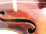 a close up of a violin that is on a table