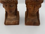 pair of carved wooden head sculptures of a woman and a man