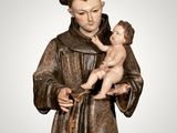 a statue of a man holding a baby in his arms