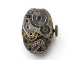 an image of a close up of a watch movement on a white surface