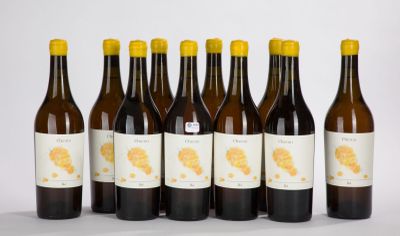 six bottles of wine are lined up in a row on a white surface