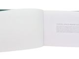 an open book with a white cover and green pages
