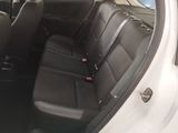 the back seats of a white car with black seats in it
