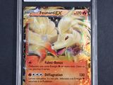 a close up of a pokemon card on a black surface