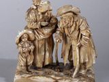 carved ivory figurine of a group of people with a child