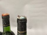 three bottles of wine that are sitting on a table