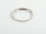 a close up of a diamond ring on a white surface