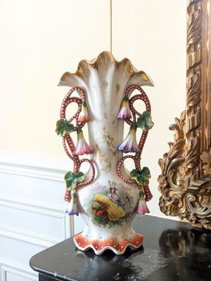 a vase that is sitting on a table next to a mirror
