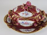 a red and gold plate with a bowl on it