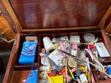 a wooden box filled with sewing supplies on a table