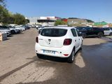 a white car parked in a parking lot next to other cars