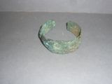 a close up of a metal bracelet on a table