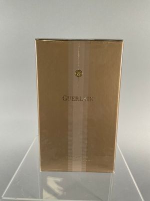 a box of perfume sitting on a glass table