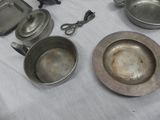 a lot of old metal pans and pans on a table