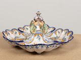a decorative bowl with a bird on it on a table