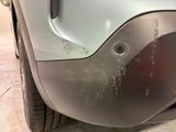 a close up of a car ' s bumper with a hole in it