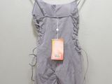 the back of a gray romper with a tag hanging on a hanger