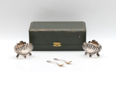 a pair of silver plated sheep figurines in a box