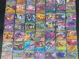 a large collection of pokemon cards sitting on top of a table