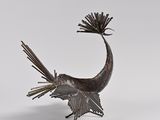 bronze sculpture of a bird with a fan on its head