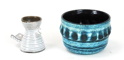 two vases sitting next to each other on a white surface