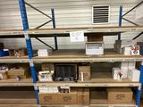a shelf with boxes and a microwave on it in a warehouse