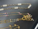 a lot of necklaces that are laying on a table
