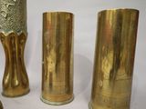 three gold vases sitting next to each other on a table