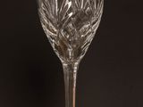 an empty wine glass sitting on top of a wooden table
