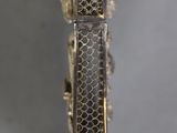 silver and gold bracelet with a snake skin design on it