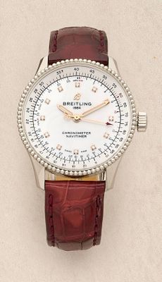 a close up of a watch on a white surface