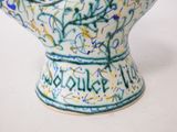 a blue and white vase with writing on it