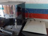 a coffee maker and a coffee cup sitting on a table