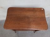 a small table with a wooden top on a concrete floor
