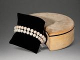 two pearls and a hat on a table with a hat on it