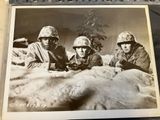 an old photo of a group of soldiers sitting on top of a snow covered ground