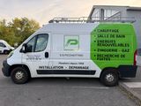a white van parked in a parking lot with a green sign on the side of it