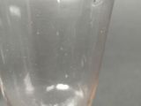 a clear glass with a small hole in it