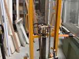 a fork lifter that is sitting in the middle of a room