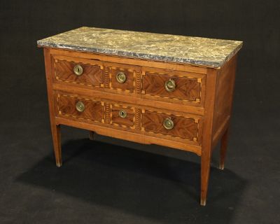 a small chest of drawers with marble top on a black background