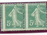 two stamps with a woman on them on a white surface
