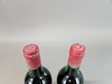 two bottles of wine sitting next to each other on a table