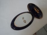 a black and white plate with a gold design on it