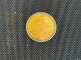 an image of a gold coin on a black mat