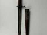 pair of old and rusty knifes on a white surface